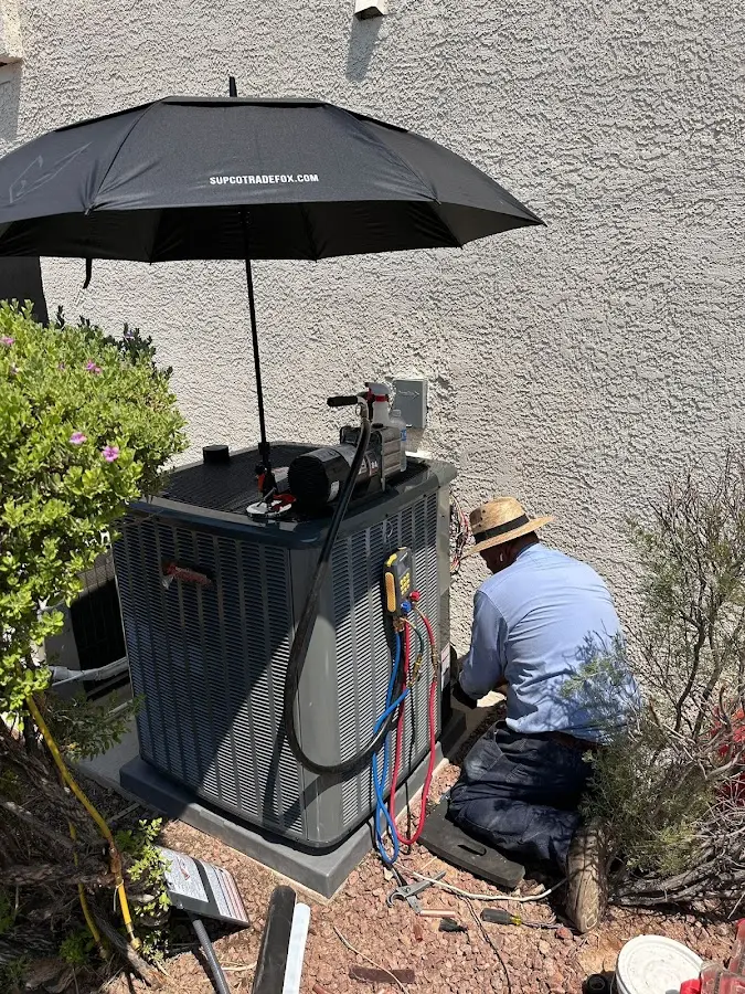 HVAC technician performing outdoor AC maintenance in Emmett
